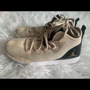 cream and black nike jordan’s